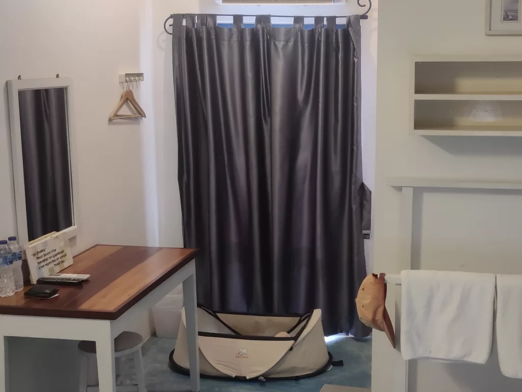 Hotel room with baby pop-up tent in Thailand. The tent is part of our tips for traveling to Thailand with a baby.