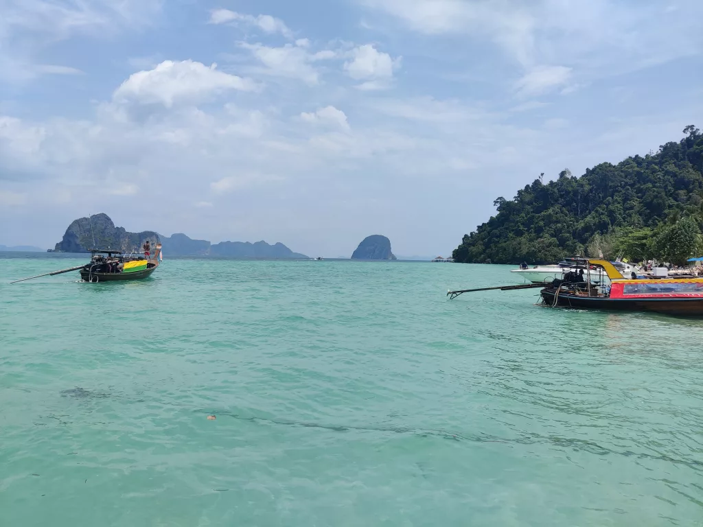 Turquoise water and scenery with long-tail boats in Koh Ngai, Thailand.
The island is a highlight in our Thailand Travel Itinerary.