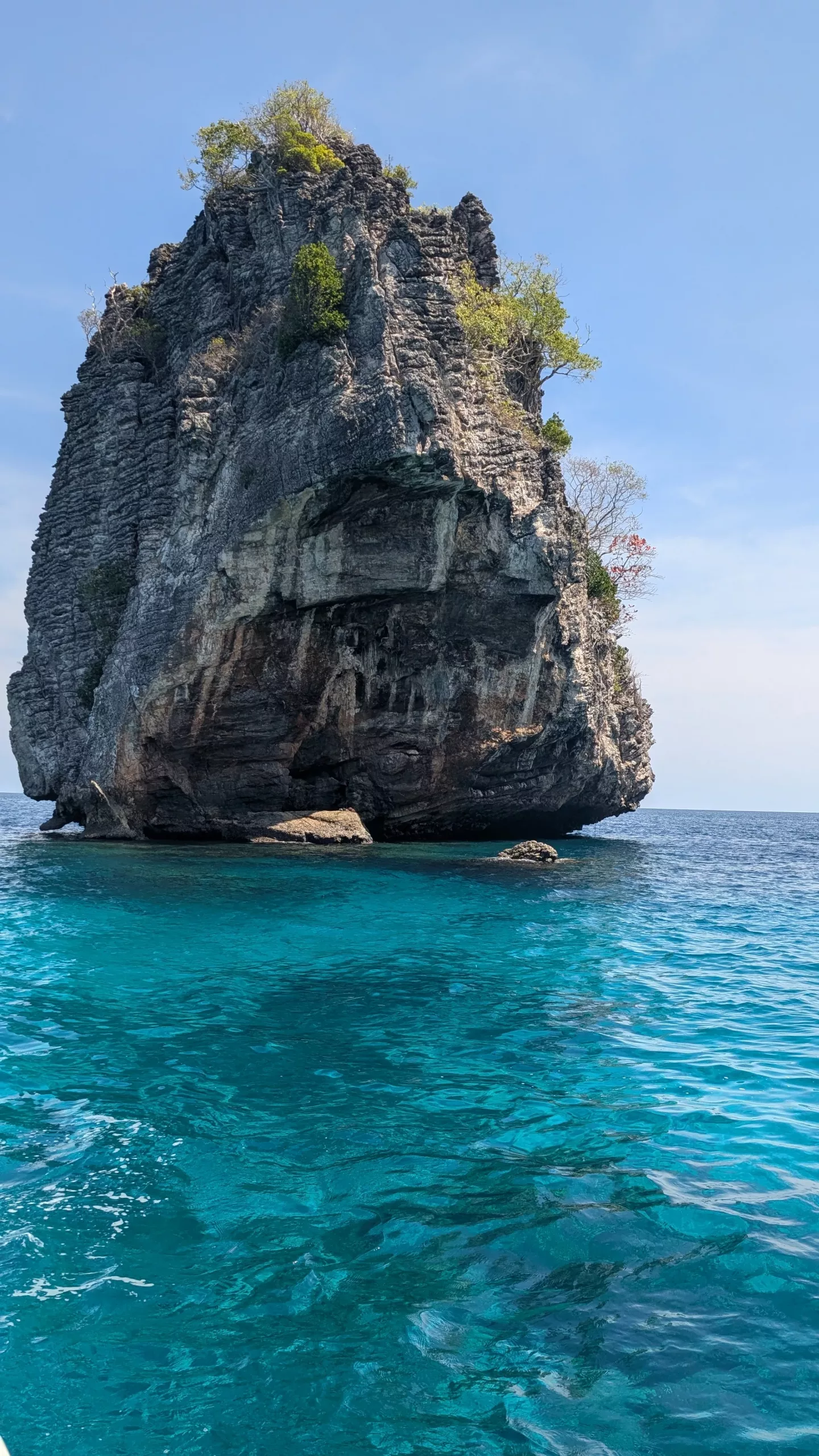 A rock in turquoise water in the Andaman Sea, Thailand